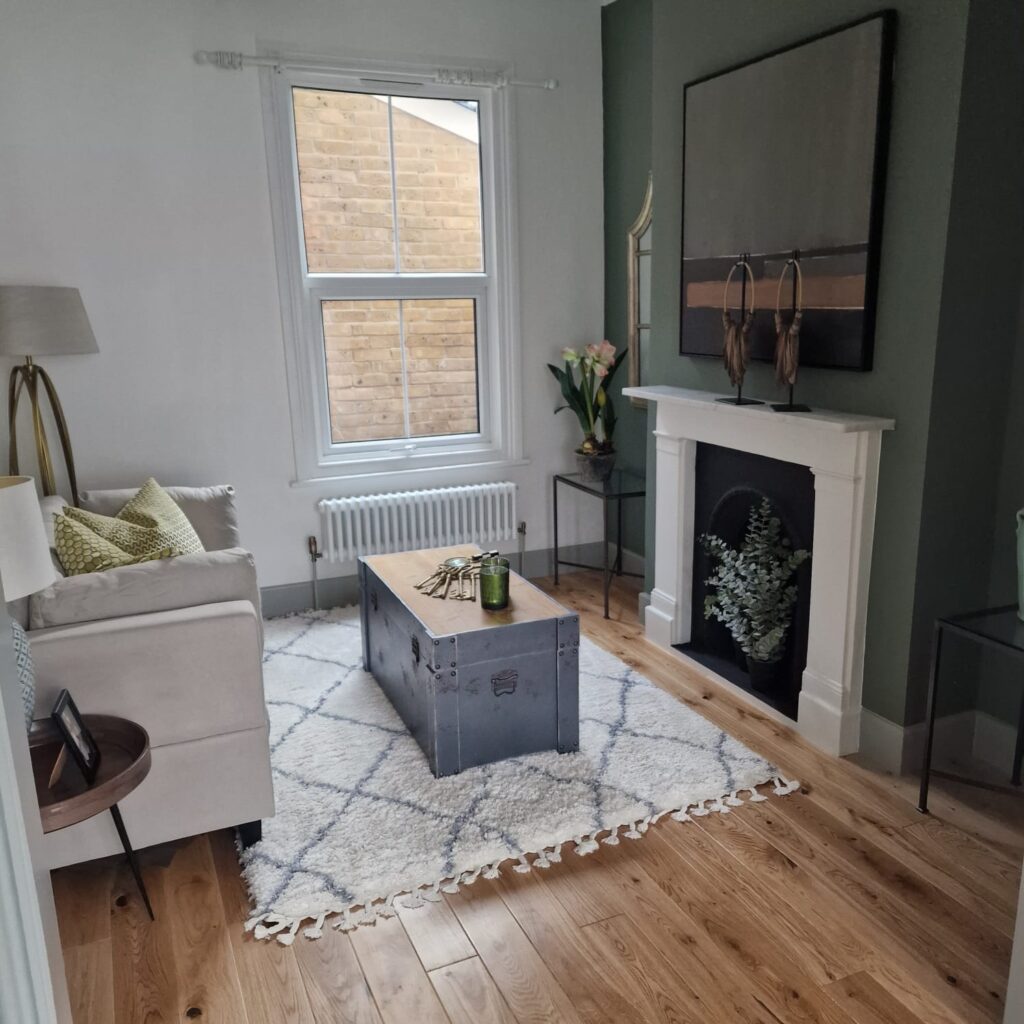 Living Room & Bedroom Renovation | London & Home Counties 6 A living room featuring a beige sofa, a wooden coffee table, and decorative items. - London