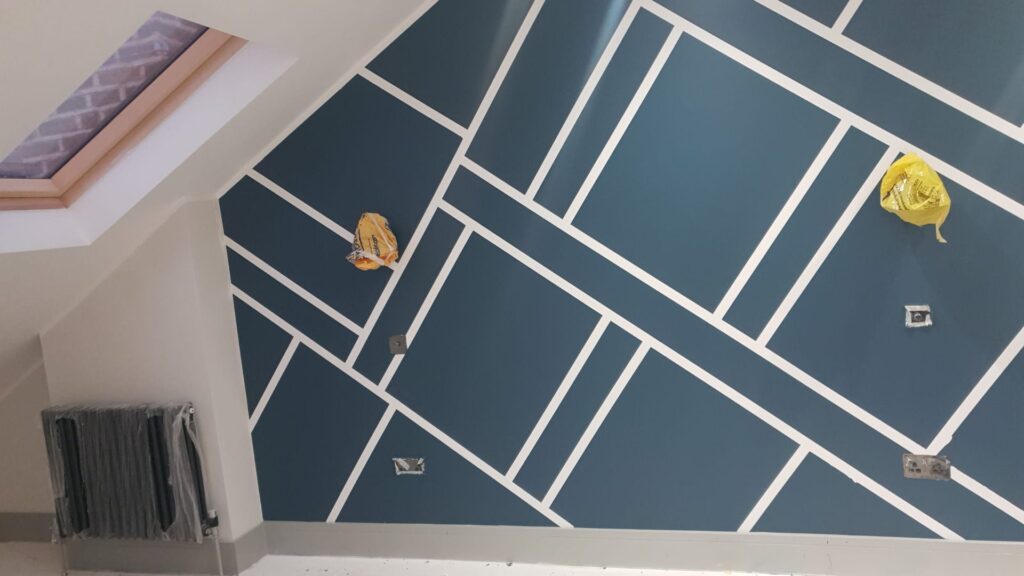 Living Room & Bedroom Renovation | London & Home Counties 20 Wall featuring a geometric pattern in blue and white with two yellow objects attached. - London