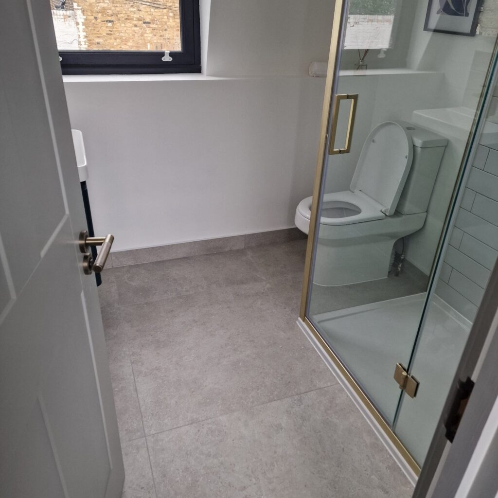 Interior view of a modern bathroom featuring a shower enclosure and toilet. - London