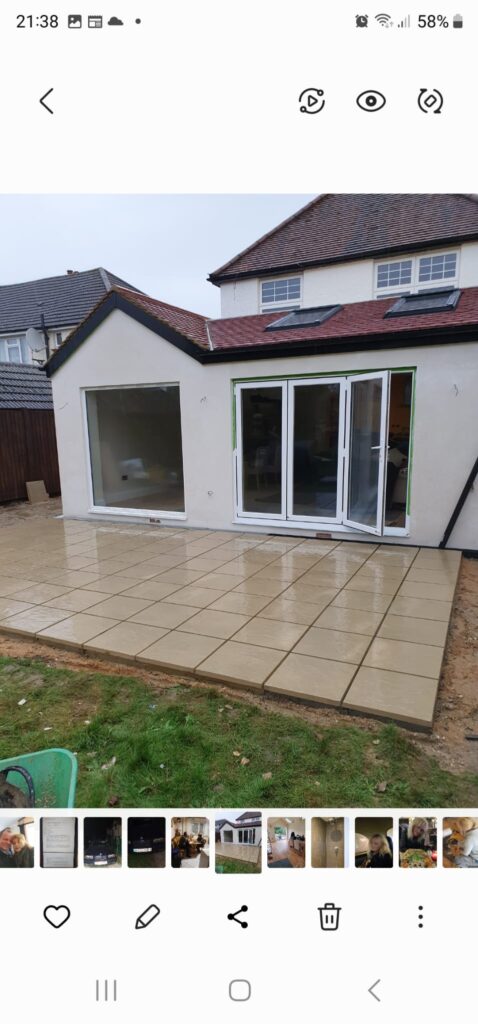 Garden Buildings & Outdoor Spaces | London & Home Counties 13 A newly paved patio area with large sliding doors leading into a building. - London