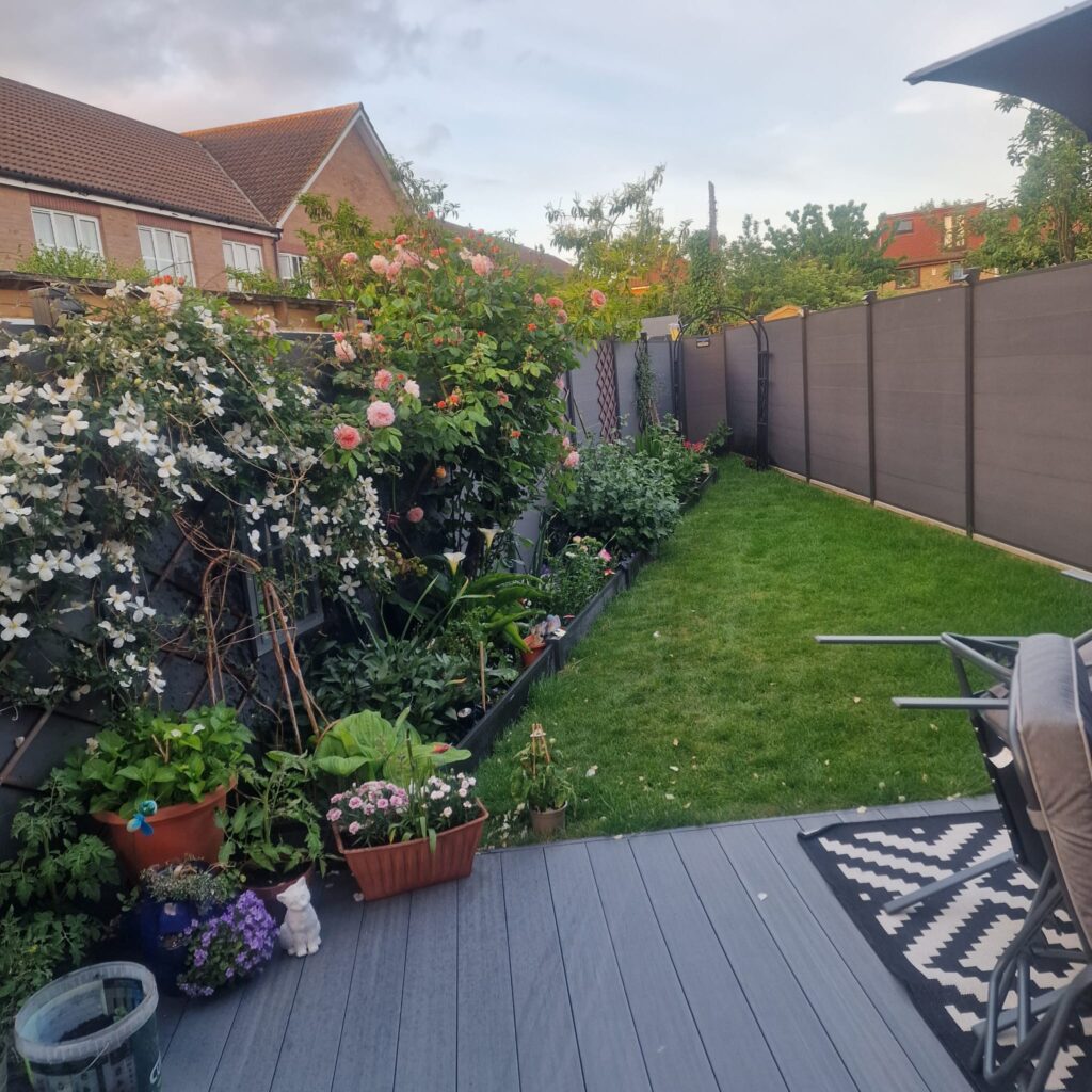 Garden Buildings & Outdoor Spaces | London & Home Counties 31 A residential garden featuring flower beds, greenery, and a small lawn area.