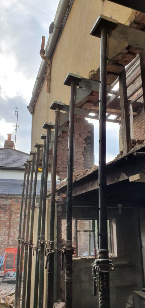 House Extensions | London & Home Counties | 30+ Years Experience 5 Construction site featuring vertical support props holding up a structure during renovation.